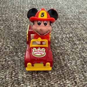 Vintage Tomy die-cast toy featuring Mickey Mouse in a fire truck